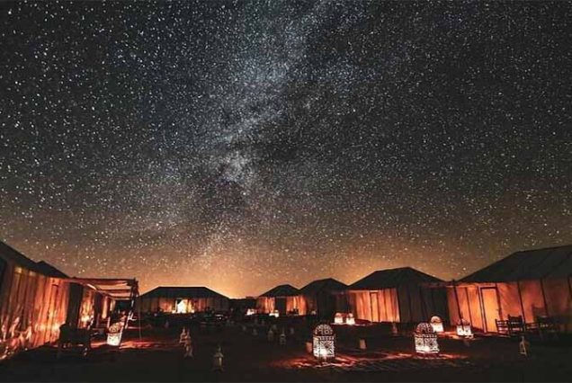 "Group enjoying Bedouin desert adventure in Marsa Alam, including camel ride, ATV ride, and cultural activities"
